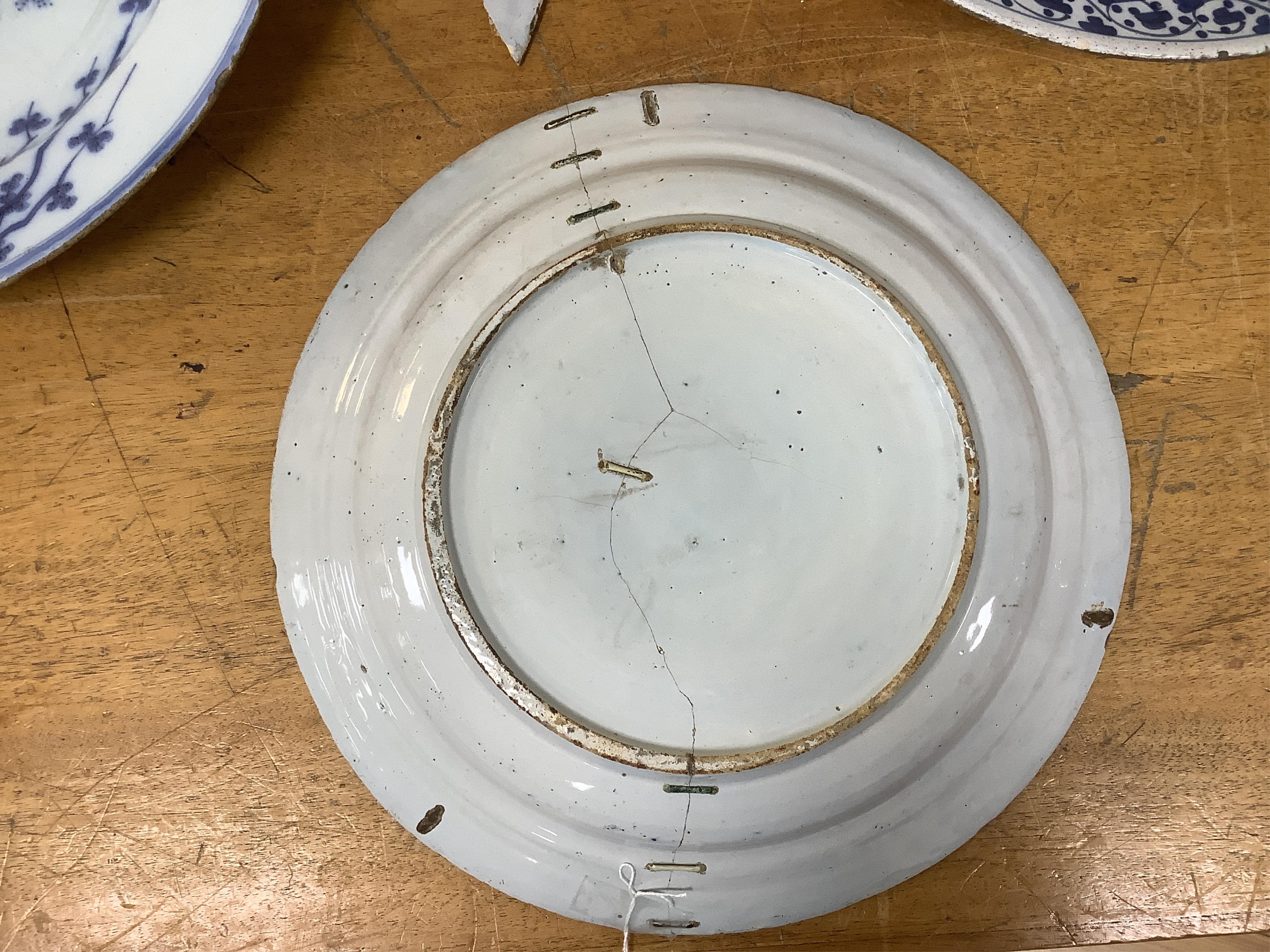 An 18th century English delftware ‘Chinese figures’ dish and two similar Delft dishes, largest 39cm diameter (3), largest 39cm
